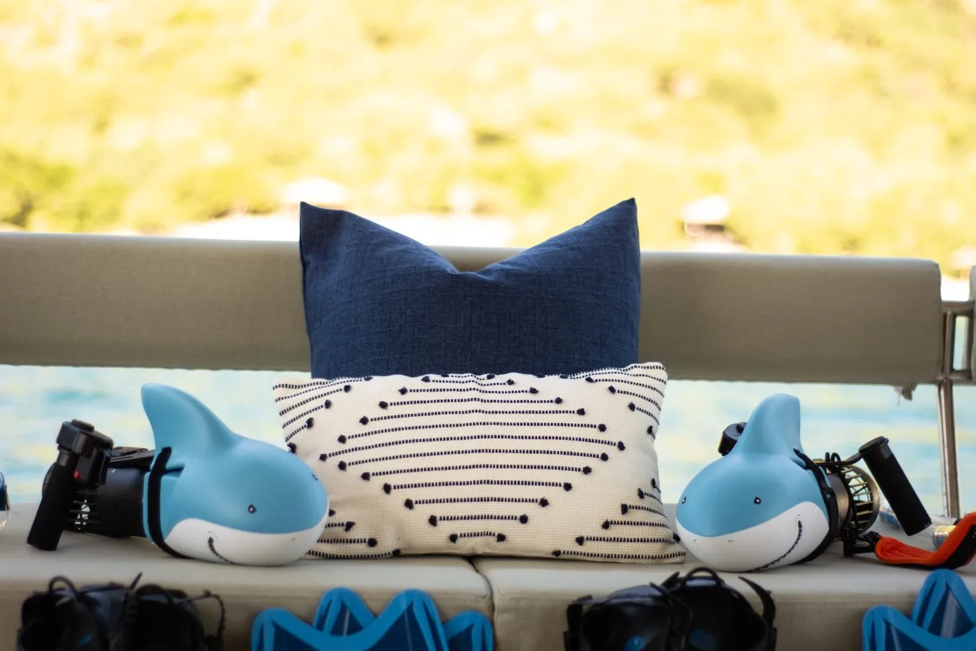 Kids’ shark-print towels and snorkel gear laid out on Allegra’s deck cushions