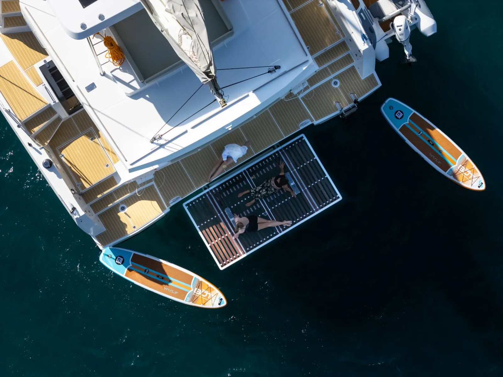 Aerial view of Allegra at anchor with paddleboards alongside