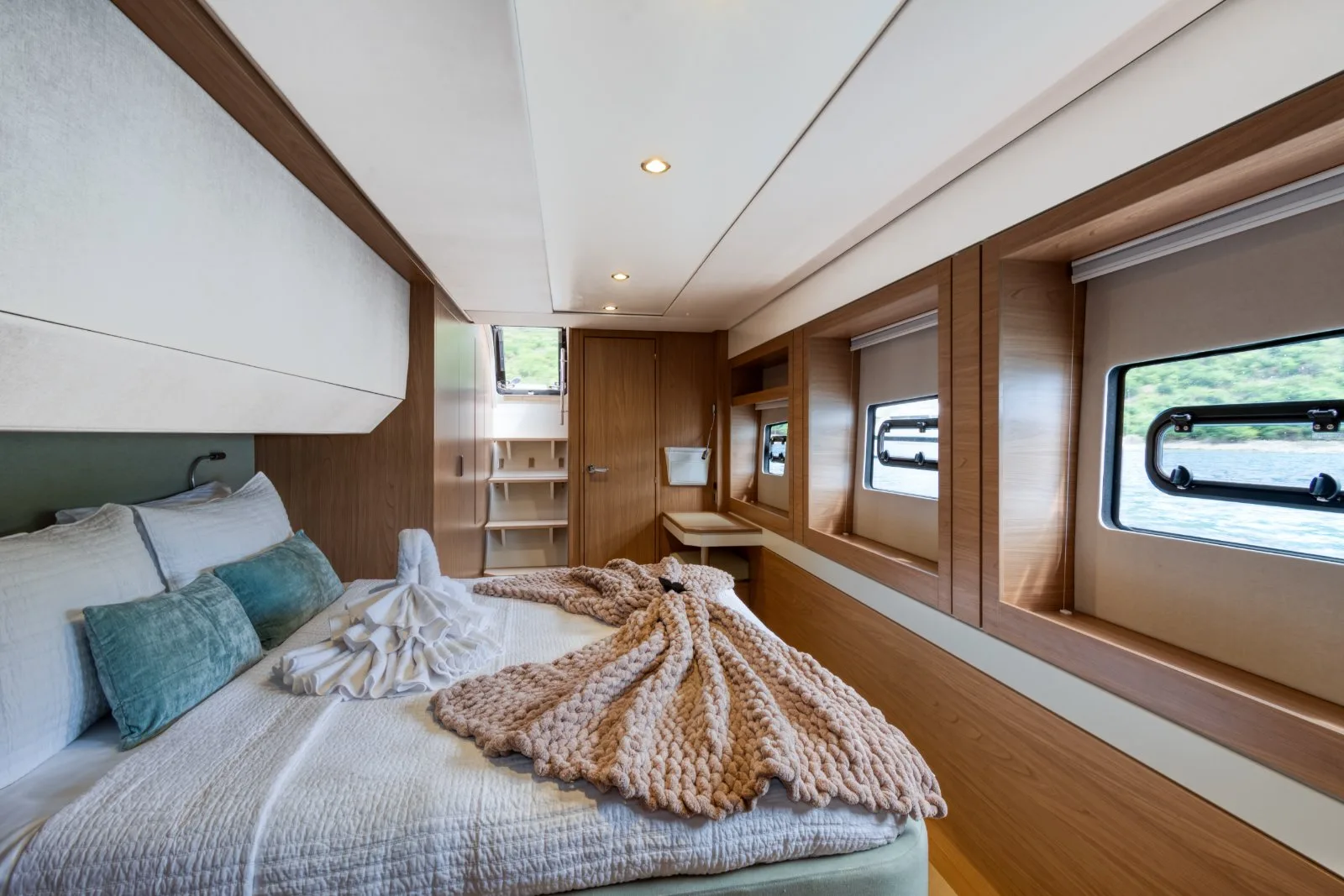 Allegra’s master cabin with a queen bed and hull-side windows