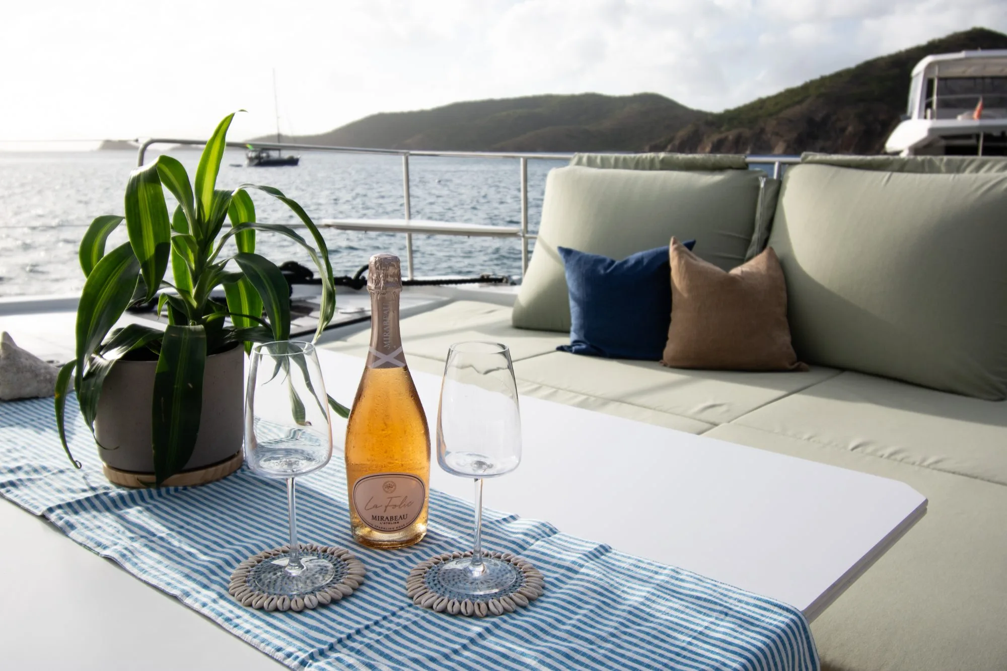 Sparkling rosé and glasses on Allegra's aft deck at golden hour